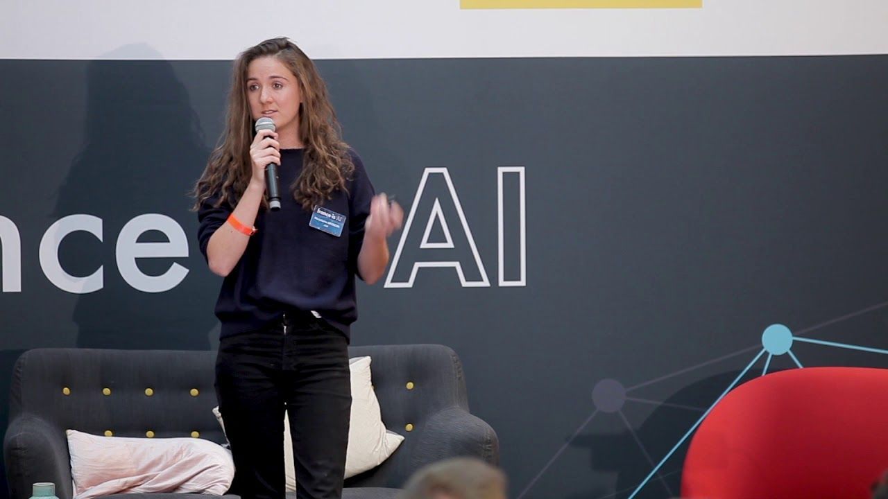 Marjolaine Grondin speaking with a microphone at an AI conference